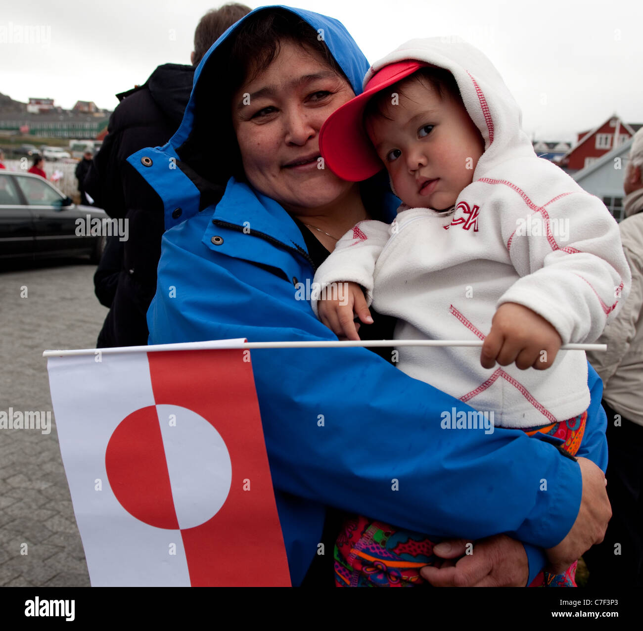 Greenlandic woman and child outside the Cathedral Annaassisitta Oqaluffia, Nuuk, on National Day, celebrating Self Governance Stock Photo