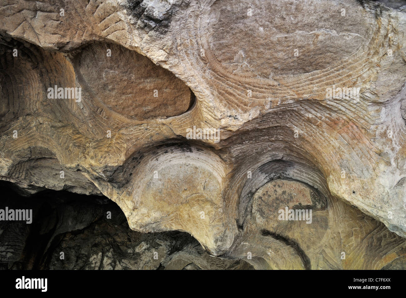 Grooves and circles in sandstone rock from carving millstones at the Hohllay cave in Berdorf, Mullerthal, Luxembourg Stock Photo