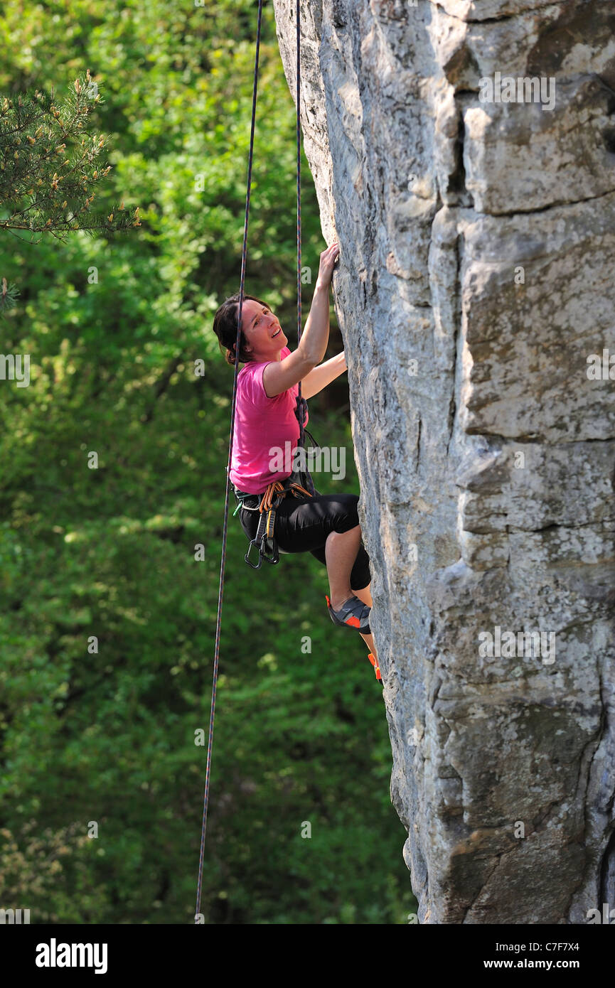 Female rock climber climbing in sandstone cliff Wanterbaach at Berdorf, Little Switzerland / Mullerthal, Luxembourg Stock Photo