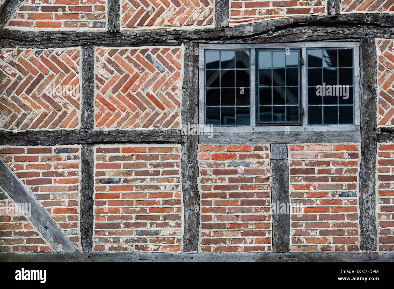 Old Oak timber framed house with Herringbone brickwork pattern. Whitchurch, Buckinghamshire, England Stock Photo