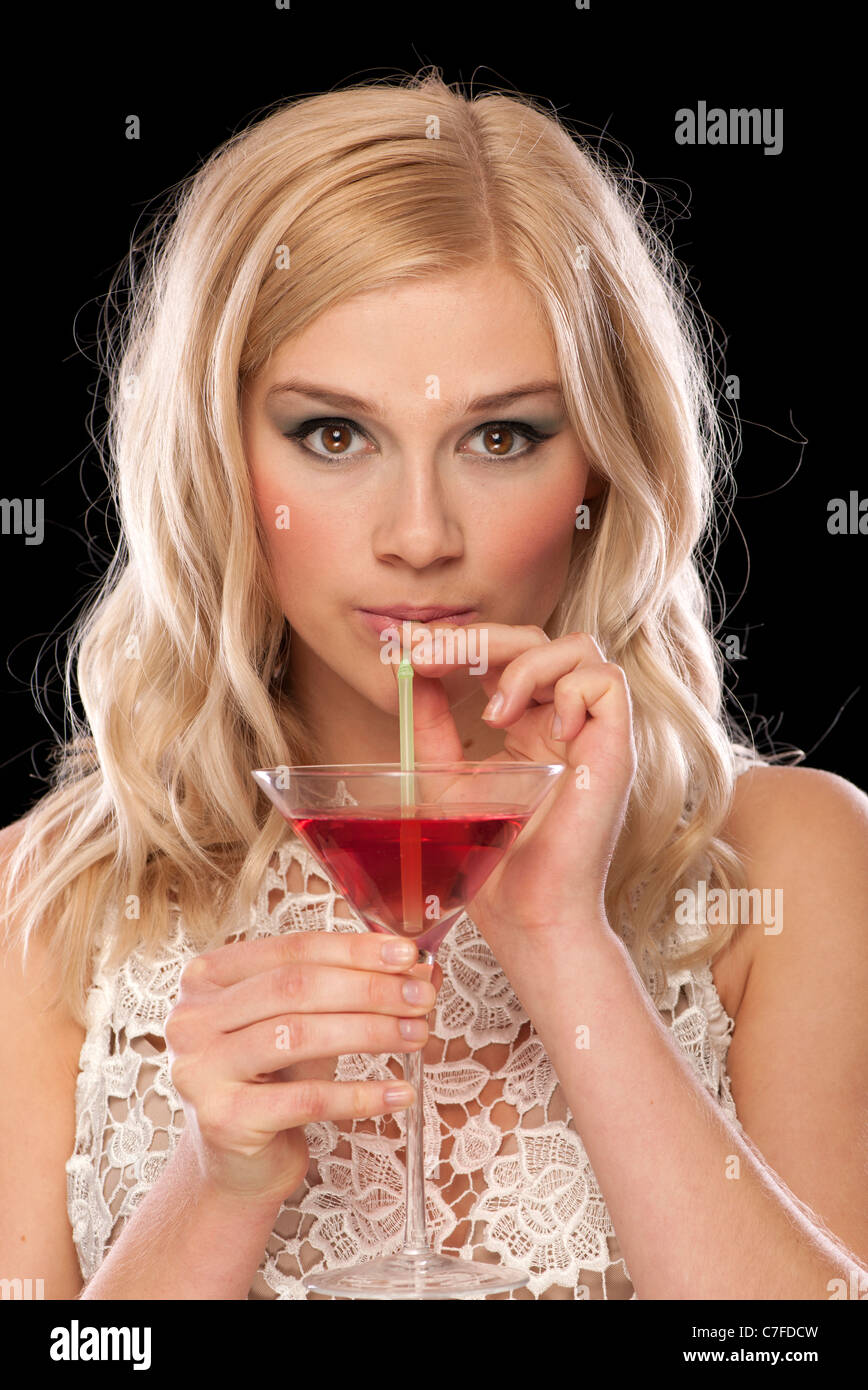 woman drinking a cocktail with a straw Stock Photo