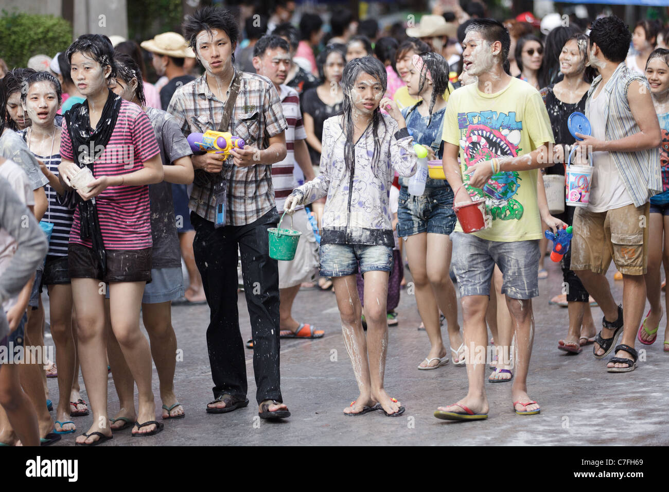 Thai teenagers crowd celebrating song kran buddhist new year in silom road, Bangkok, Thailand Stock Photo