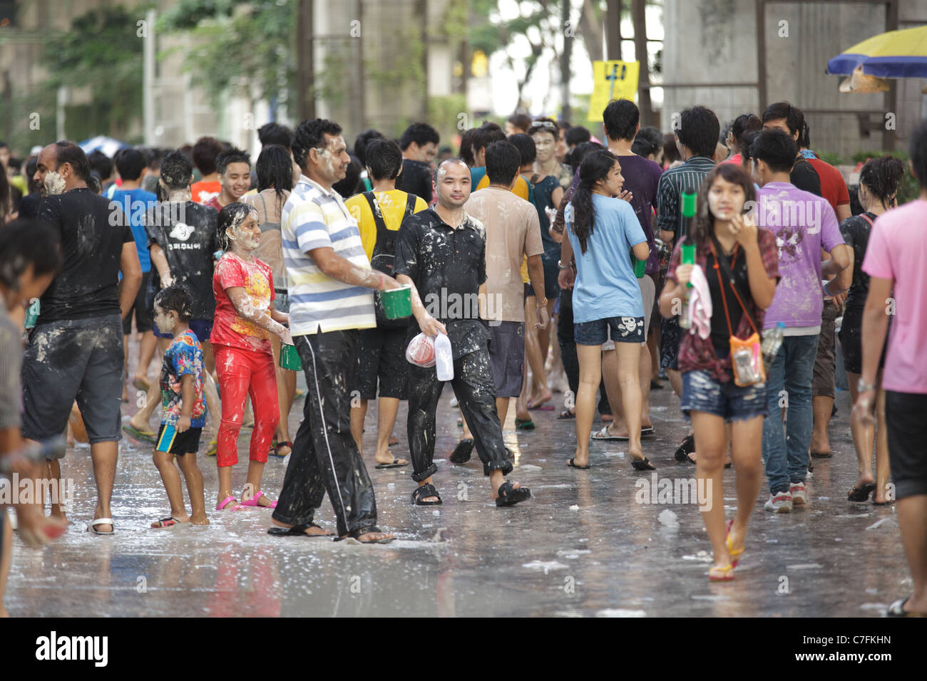 Thai people crowd celebrating song kran buddhist new year festival in silom road, Bangkok, Thailand Stock Photo