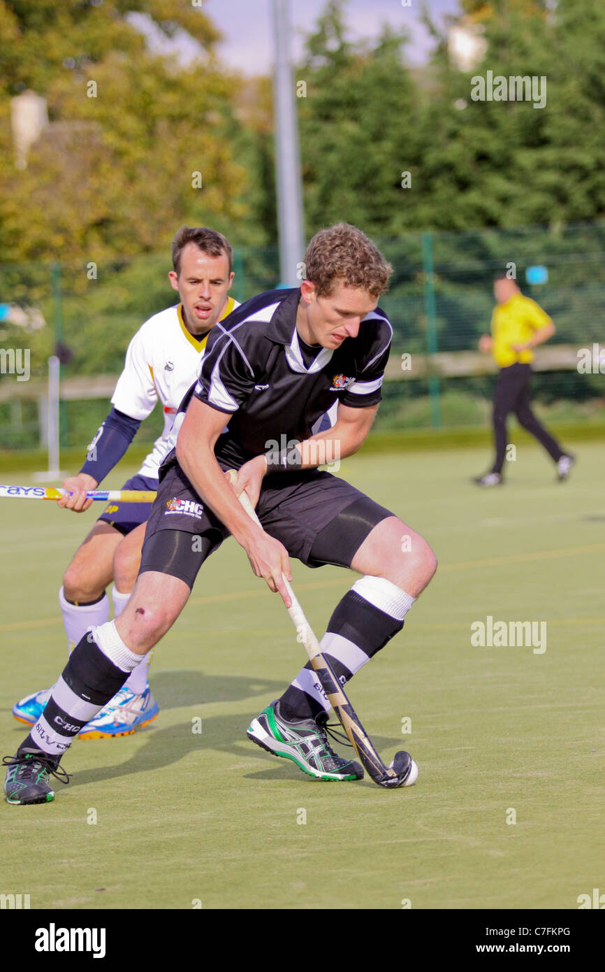 Male hockey players in action on an astro turf pitch Stock Photo