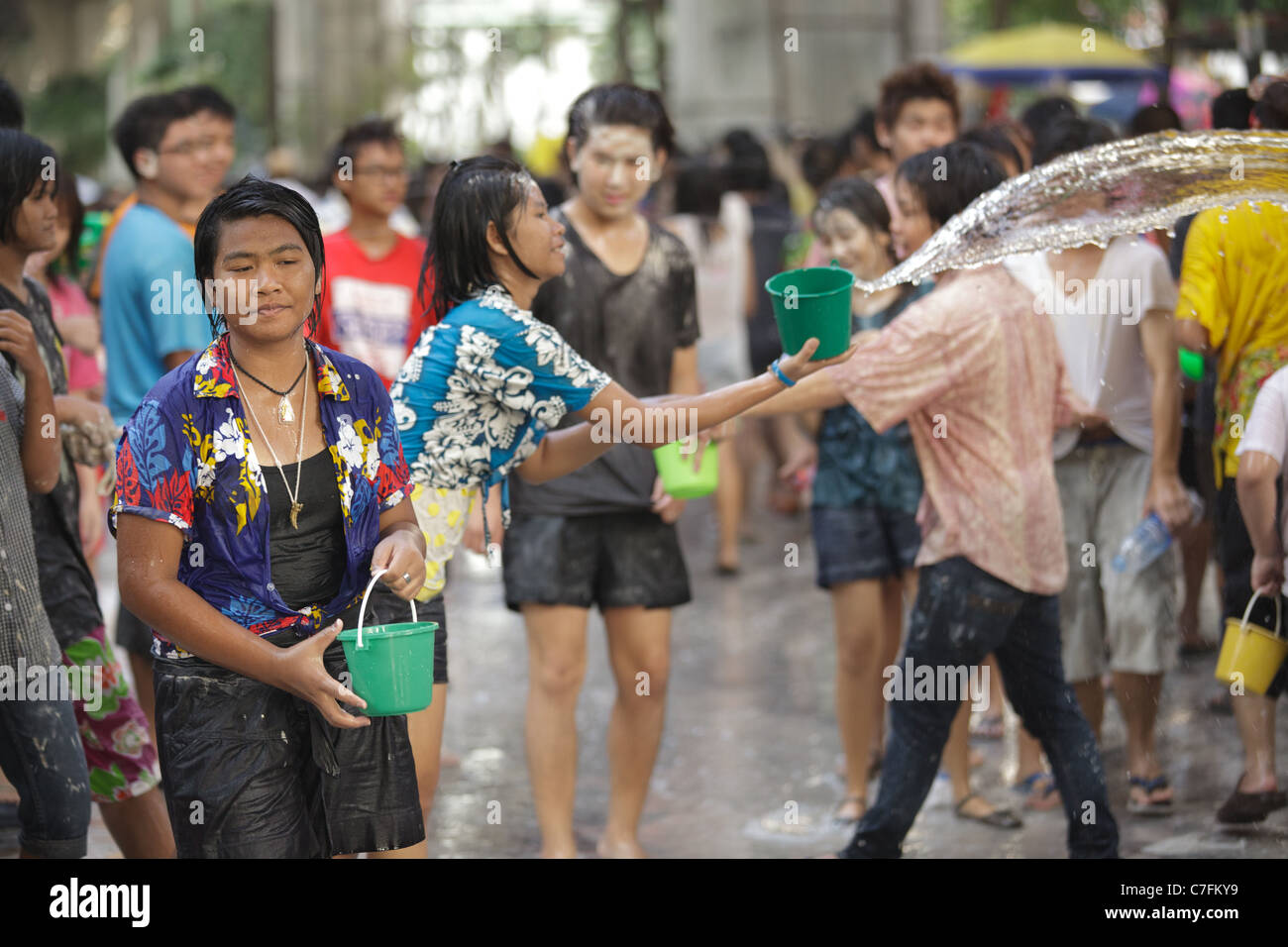 Thai people crowd celebrating song kran buddhist new year in silom road, Bangkok, Thailand Stock Photo