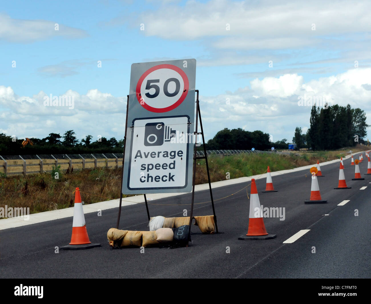 A motorway sign that warns of a speed camera and an average speed check of 50mph Stock Photo