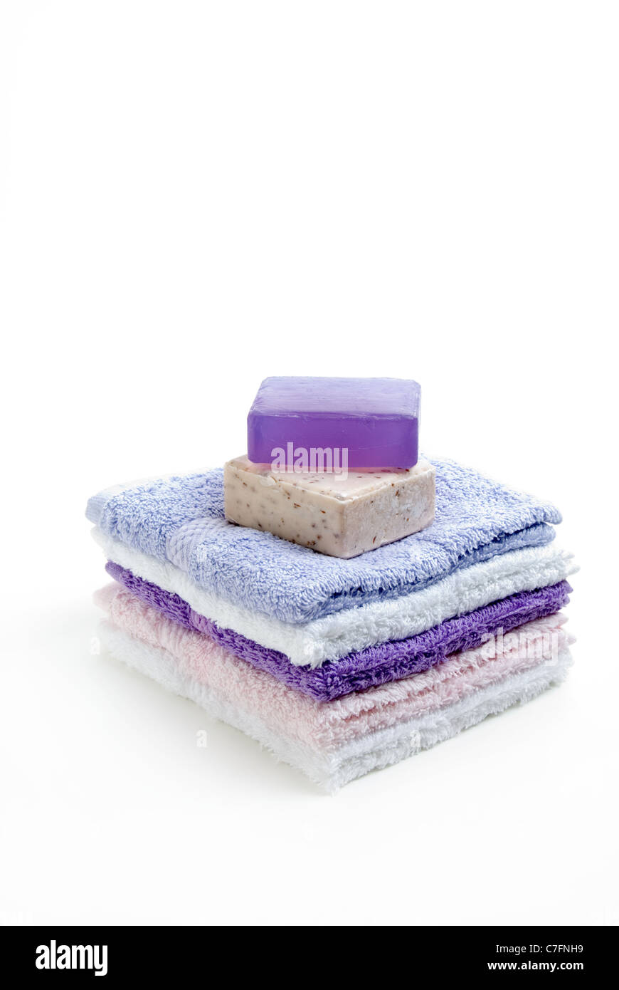 Pile Of Face Flannels with soap on white background. Stock Photo