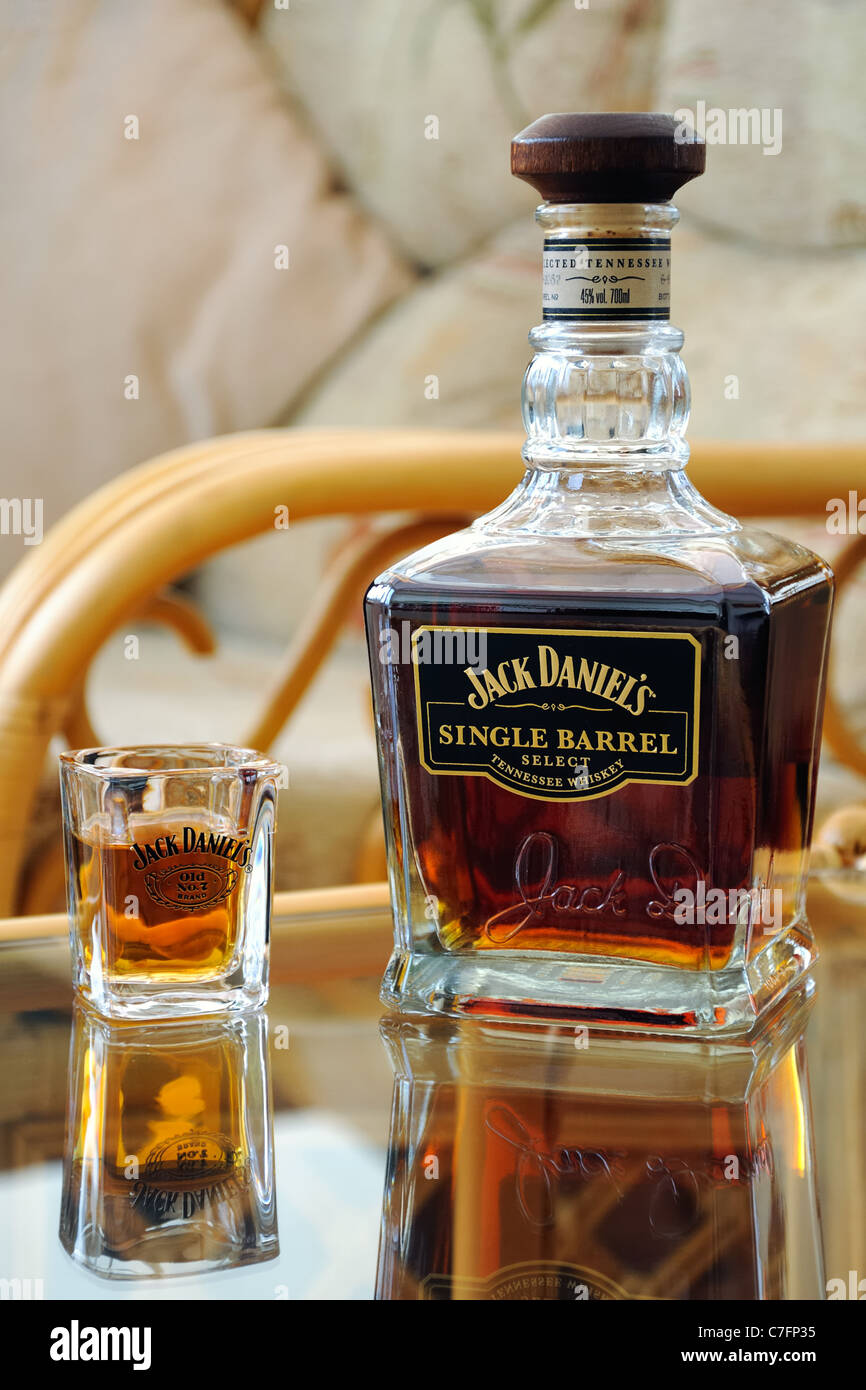 Jack Daniels Single Barrel whiskey bottle and shot glass on table Stock ...