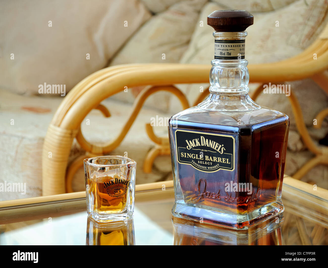 Jack Daniels Single Barrel whiskey bottle and shot glass on table Stock ...