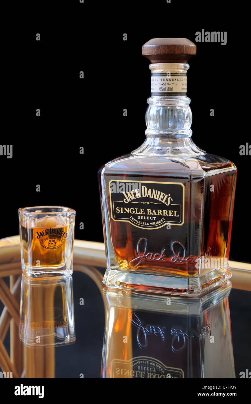 Jack Daniels Single Barrel whiskey bottle and shot glass on table Stock ...