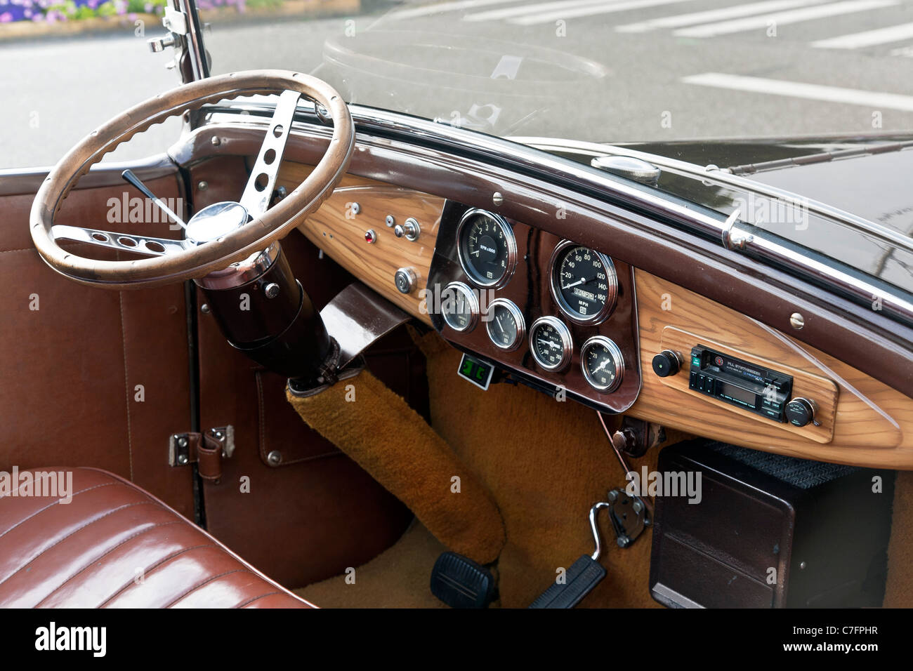 rationally designed dashboard wooden steering wheel & leather interior of classic vintage 1931 Ford Model A car parked on street Stock Photo