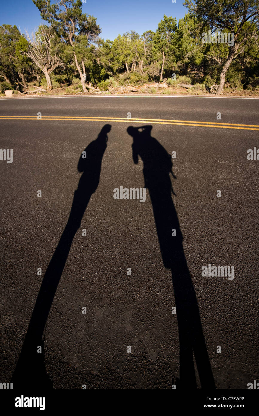 Long human shadows on asphalt - Grand Canyon National Park Arizona USA Stock Photo