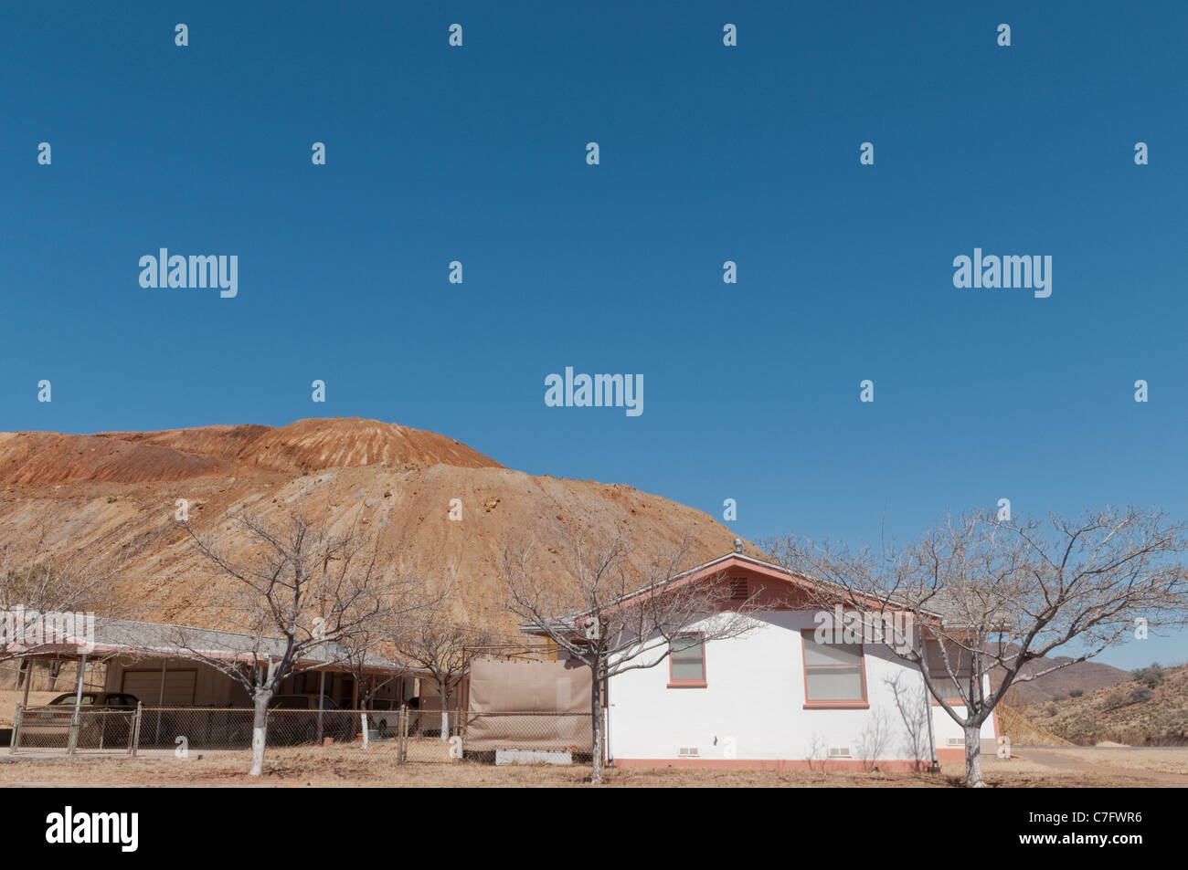 House in front of copper mine waste dump, Bisbee, Arizona, USA. Stock Photo