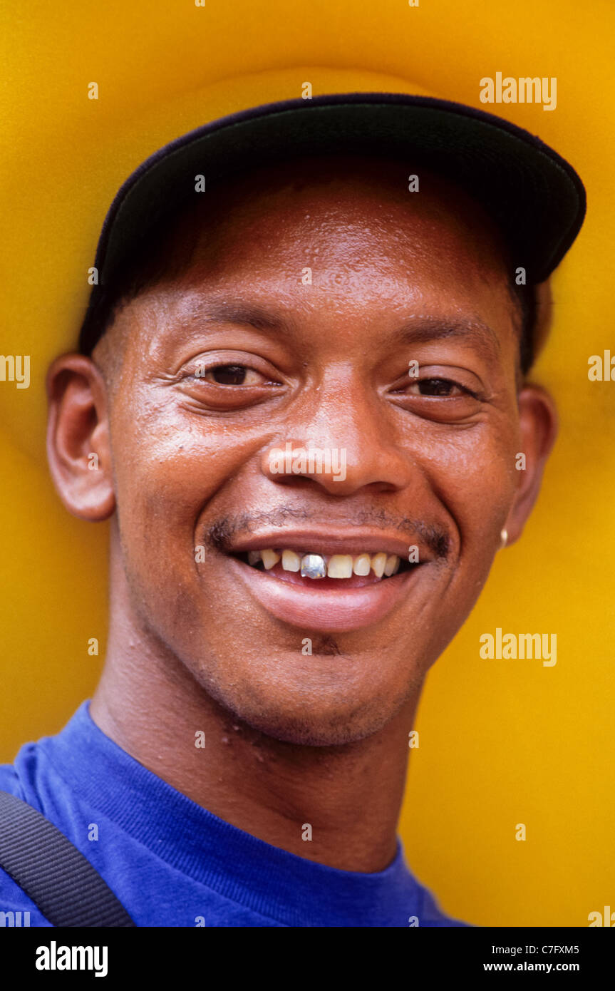 portrait of a smiling afro american with a huge yellow hat Stock Photo