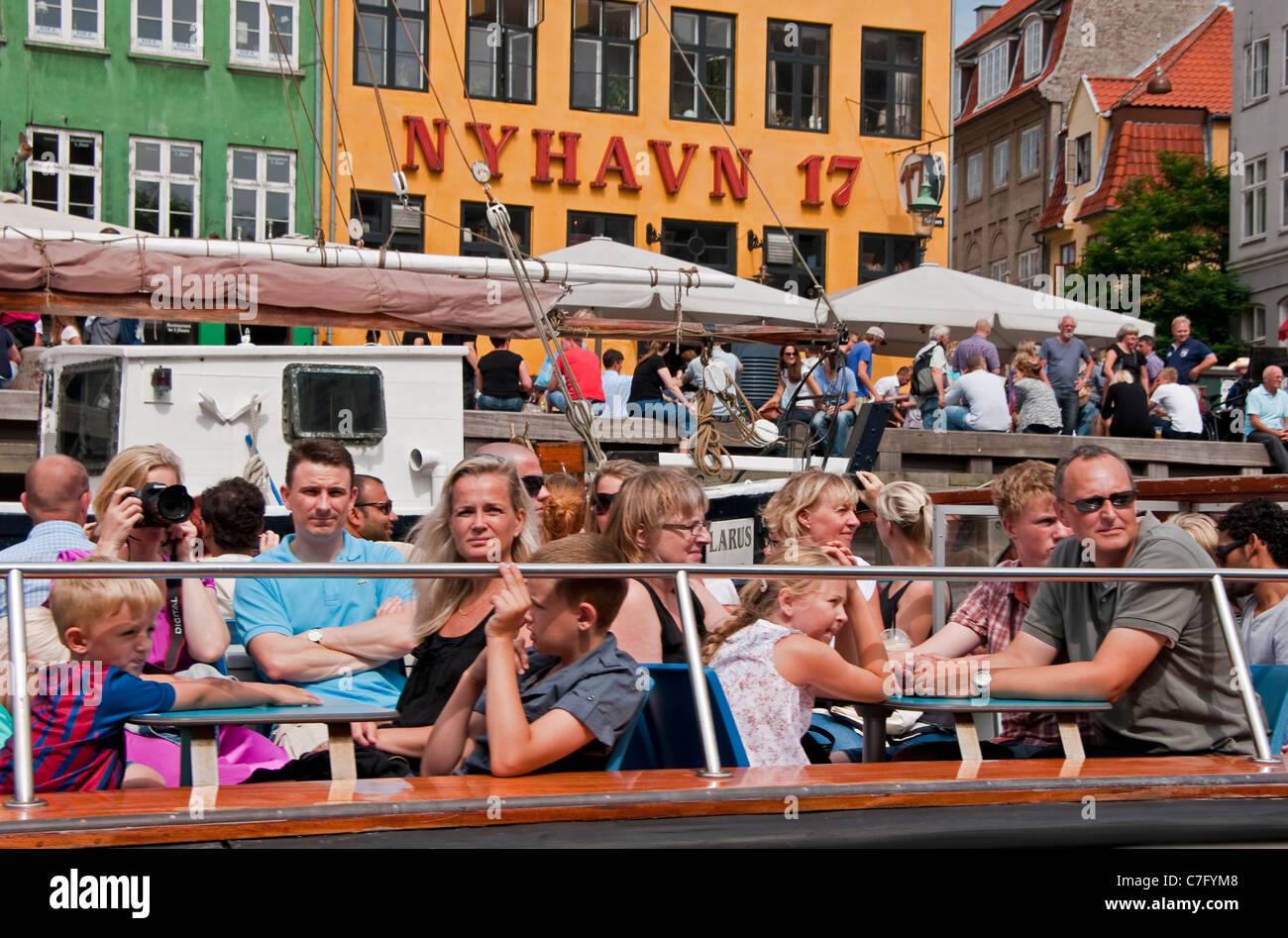 Tourists on Copenhagen canal cruise tour boat in Nyhavn Stock Photo
