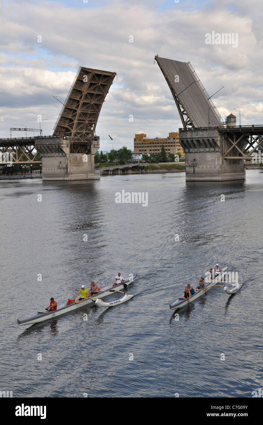 Portland Oregon residents paddle outrigger canoes along the riverfront ...