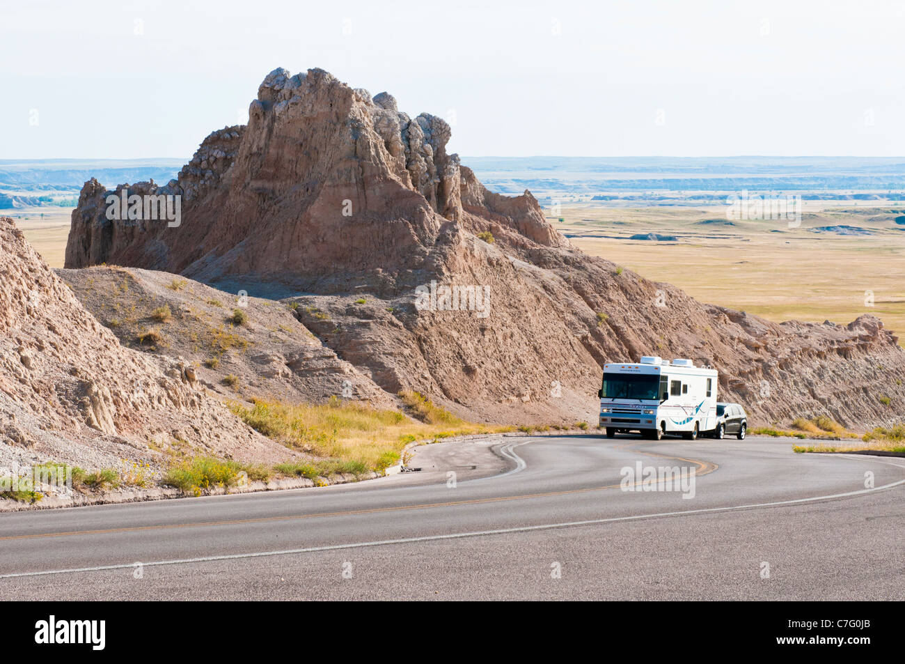 Tourists in a recreational vehicle drive through Badlands National Park