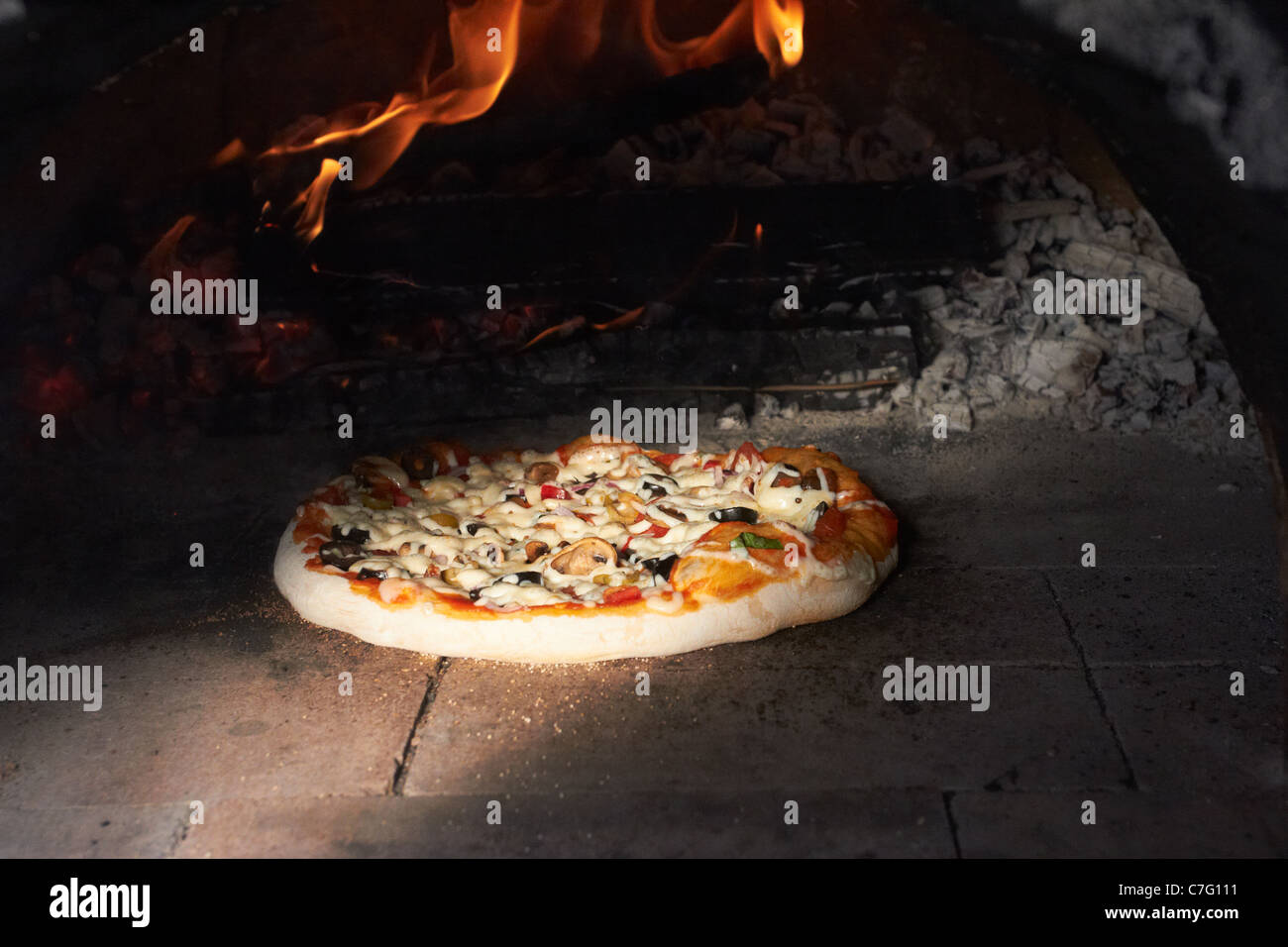 Pizza from a wood fired Earth Oven Stock Photo