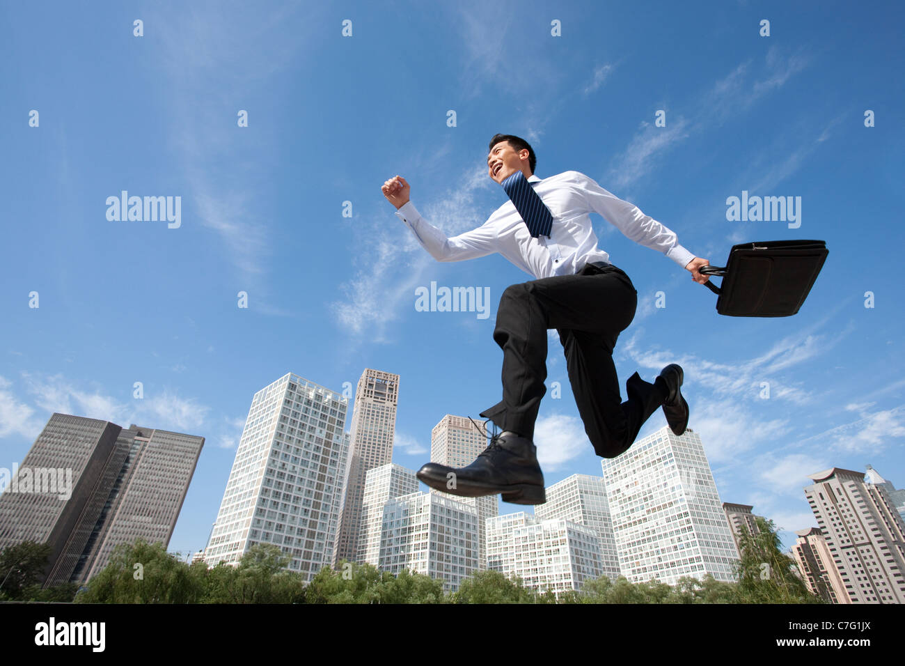 Excited Asian young man, full length portrait Stock Photo - Alamy