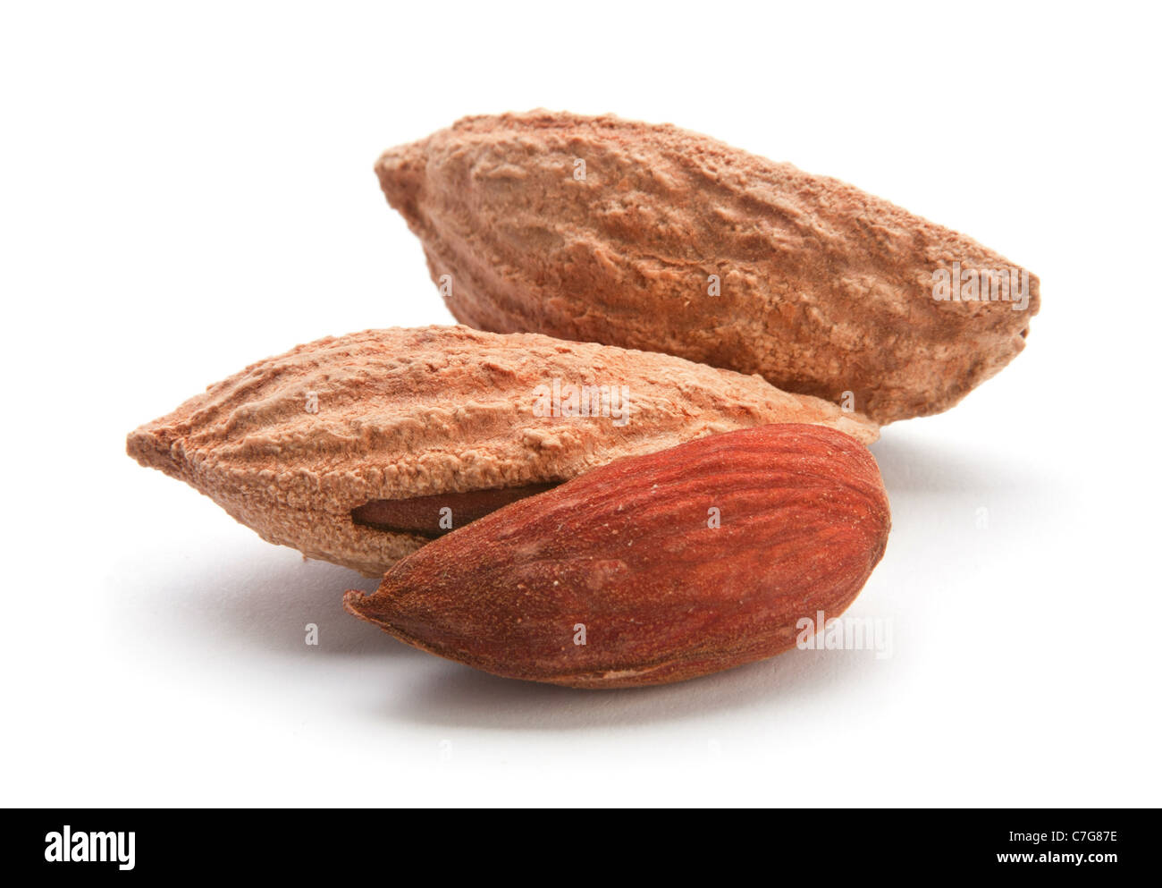 Heap almond nut closeup with shell on white Stock Photo - Alamy