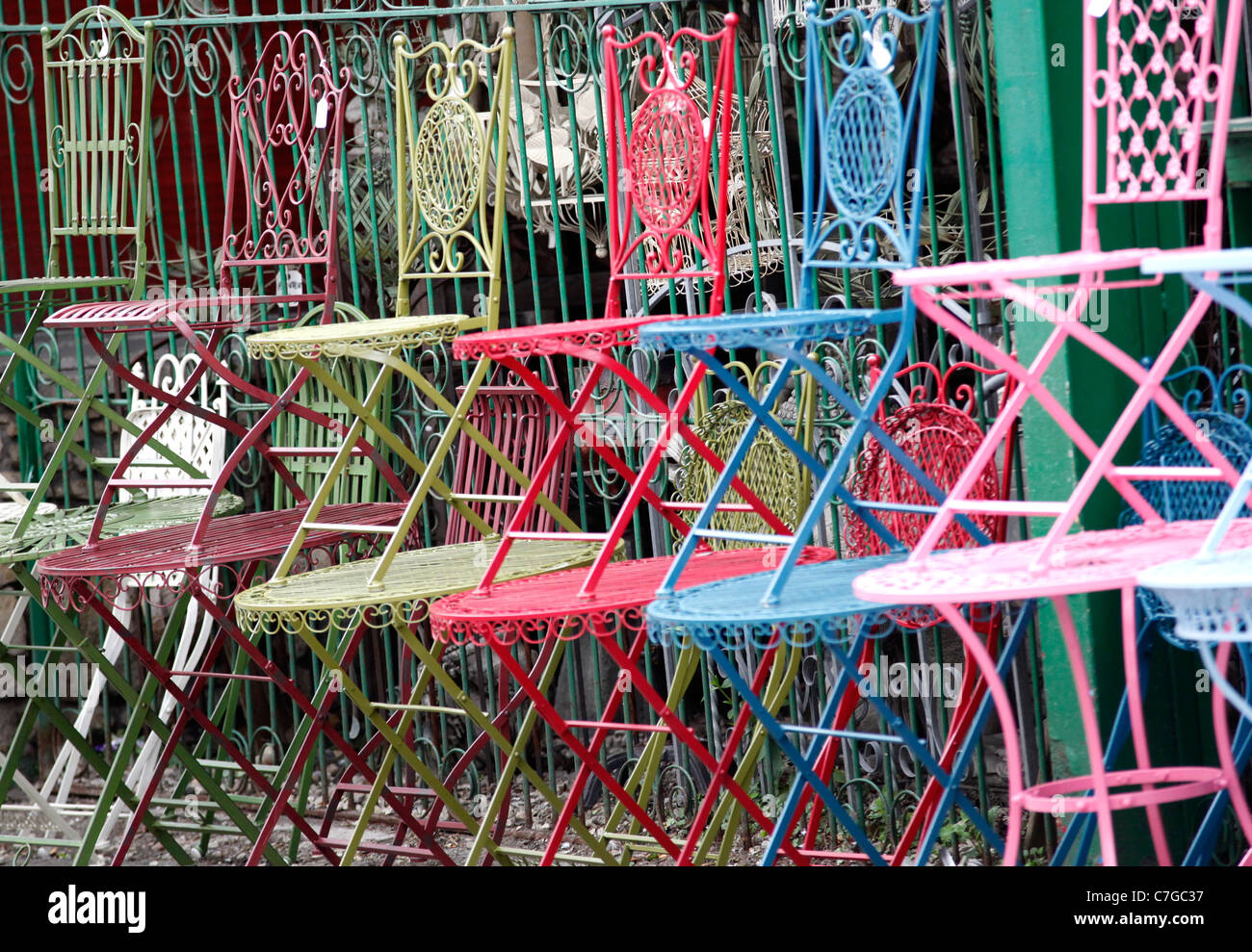 vintage iron chairs on display in a shop front Stock Photo