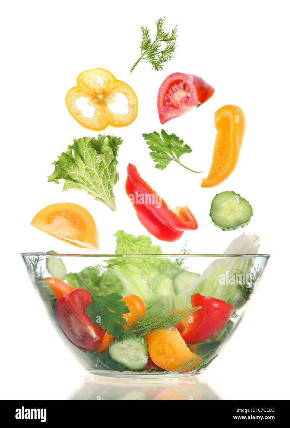 Preparing salad vegetable in galss on white Stock Photo