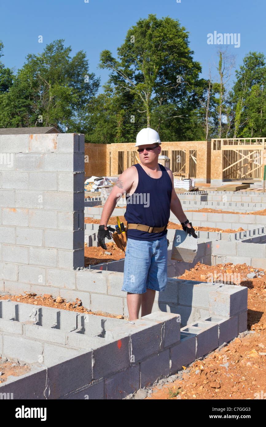 Carpenter Working On New Apartment Community Construction Stock Photo