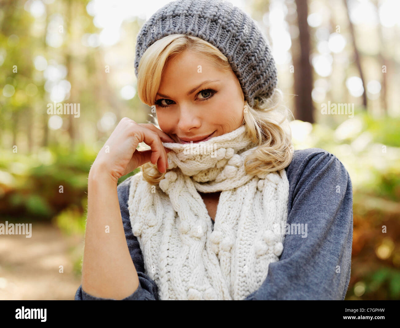 A woman looking coyly at the camera, outdoors Stock Photo Alamy