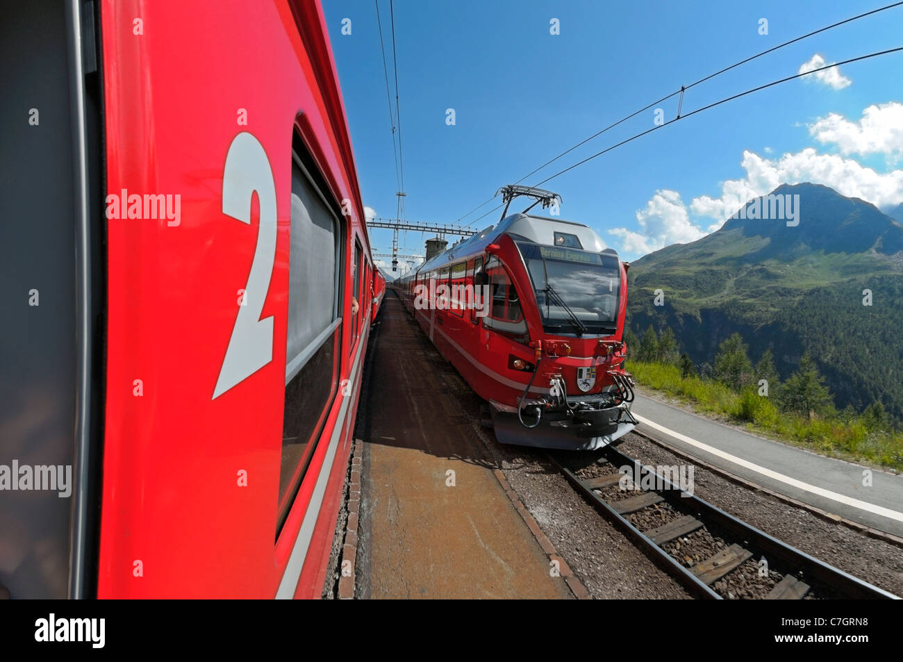 Train ride with Rhätische Bahn on the Bernina line from Ospizio Bernina to Poschiavo. Switzerland. Stock Photo