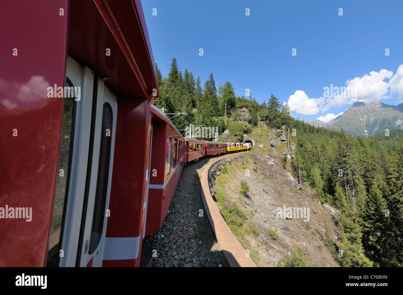 Train ride with Rhätische Bahn on the Bernina line from Ospizio Bernina to Poschiavo. Switzerland. Stock Photo