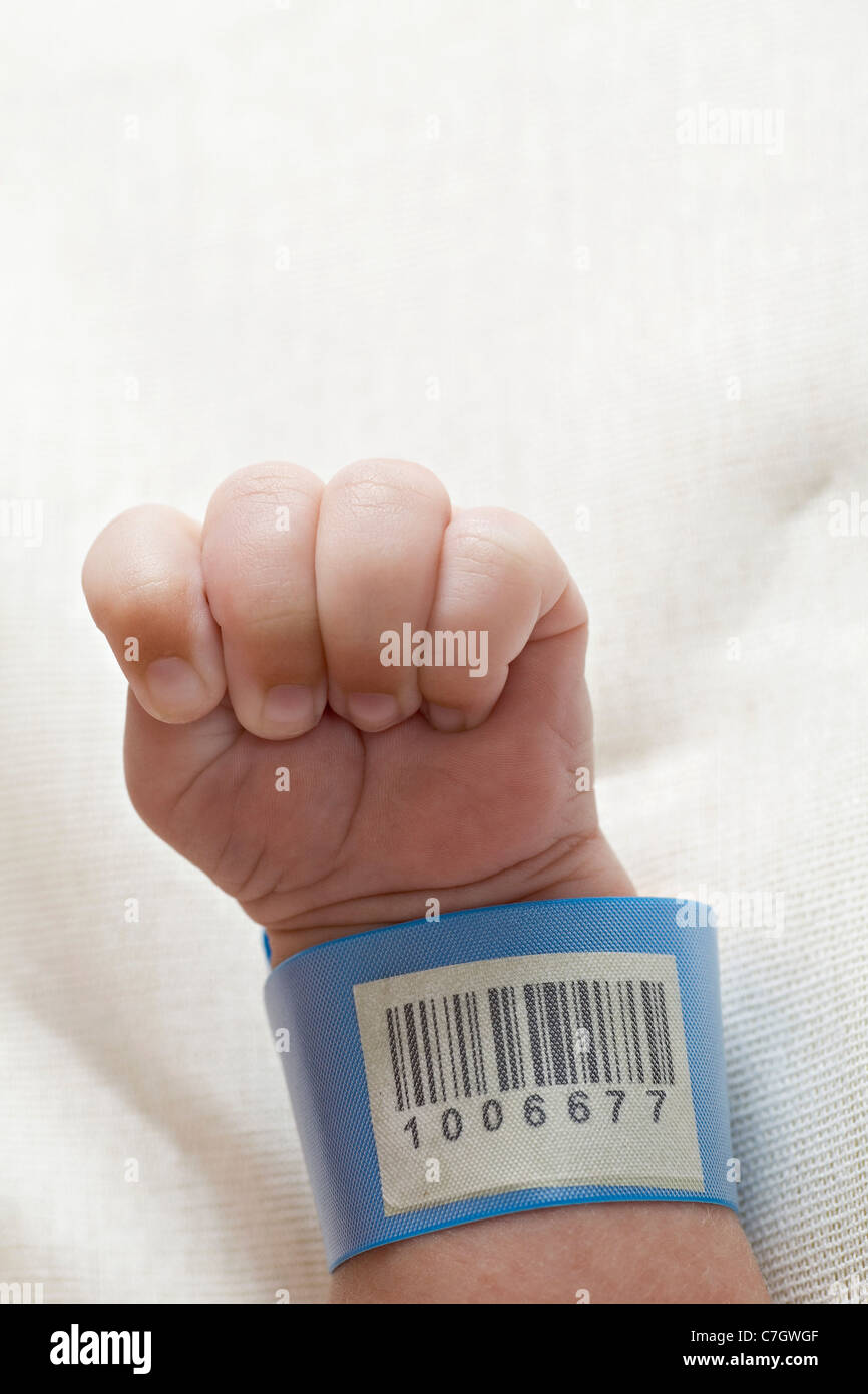 A hospital ID bracelet on a baby's wrist Stock Photo