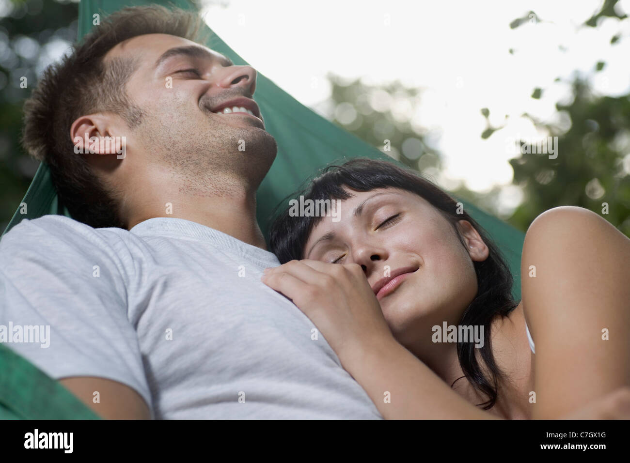 A young couple lying together in a hammock Stock Photo