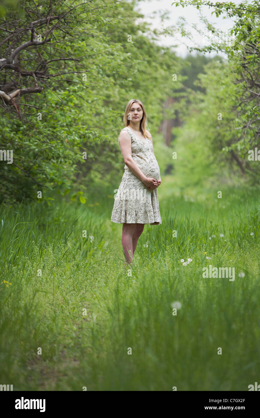 A pregnant woman holding her belly Stock Photo