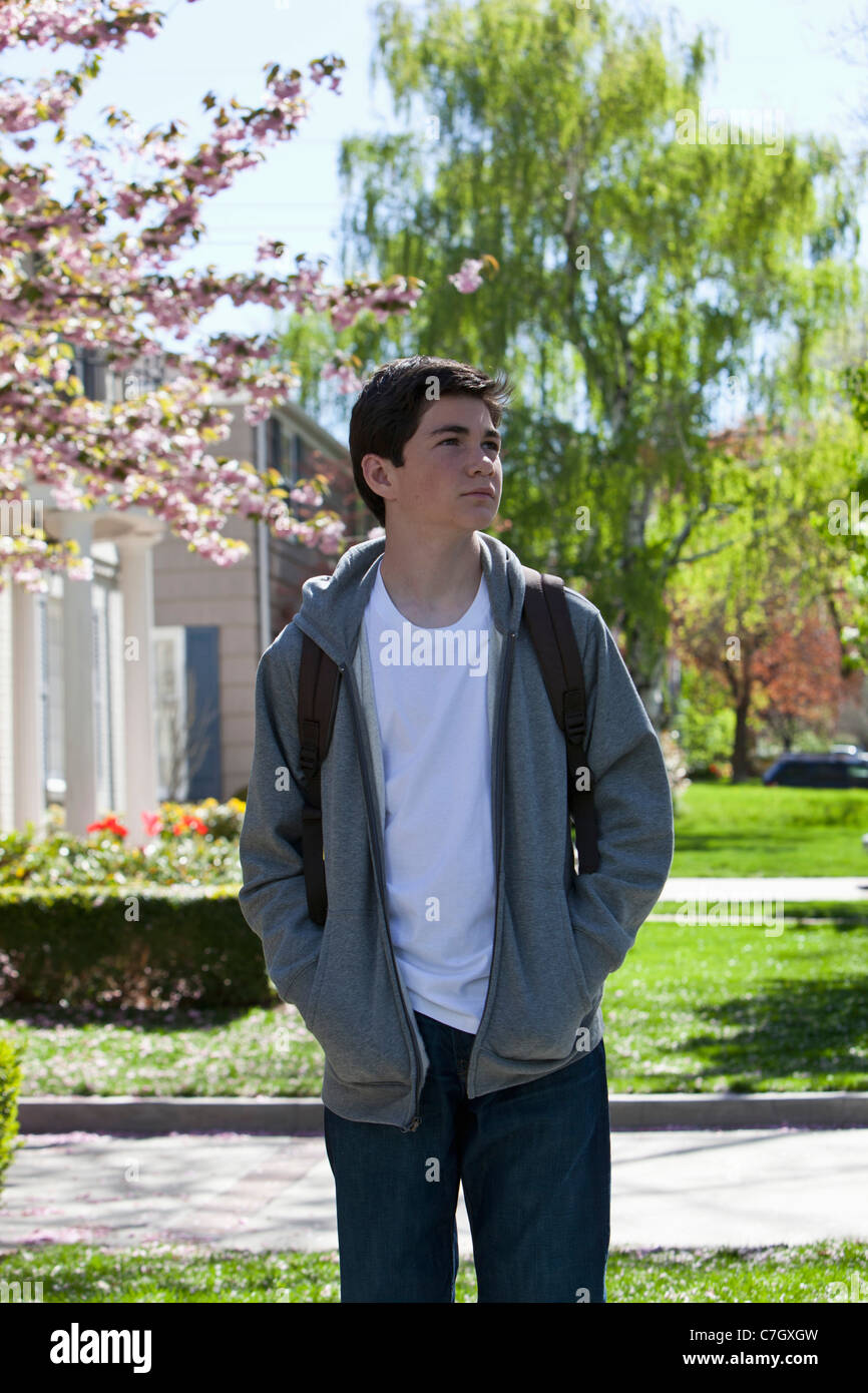 Boy with hands in pockets making decision Stock Photo