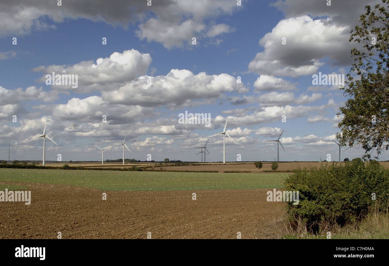 Large wind farm in the East  Midlands, England. Spectacular summer sky with clouds. Stock Photo