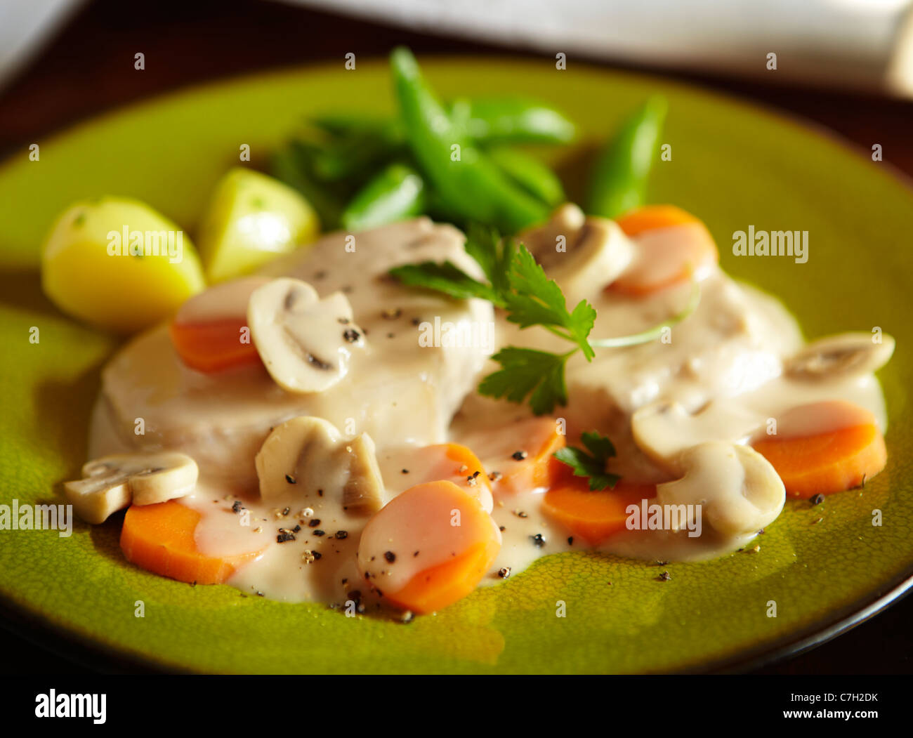Veal steaks in cream sauce with vegetables Stock Photo Alamy