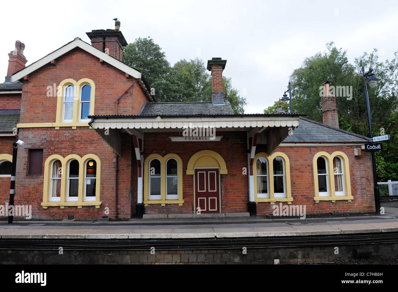 The Codsall Station pub coverted from old railway station which still has trains running past Staffordshire Uk Stock Photo