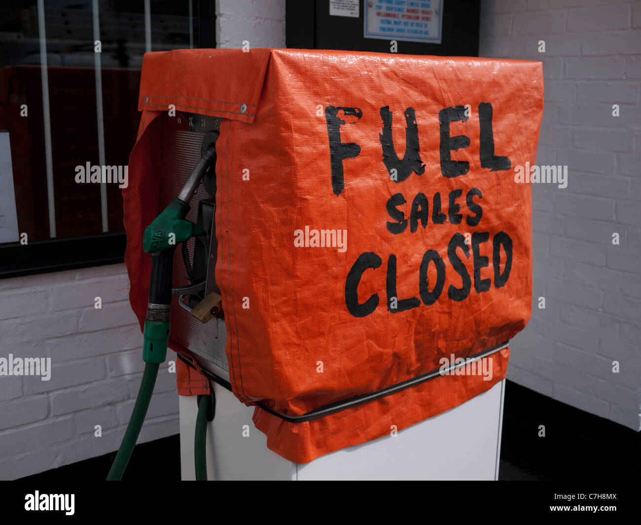 Fuel pump at garage closed due to high cost of petrol and low profits in the recession. Pump covered with closed sign. Stock Photo