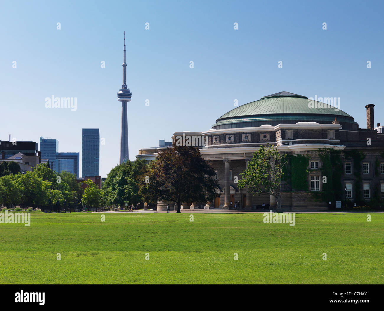 Convocation Hall building of the University of Toronto with CN tower in the background. Toronto, Ontario, Canada. Stock Photo