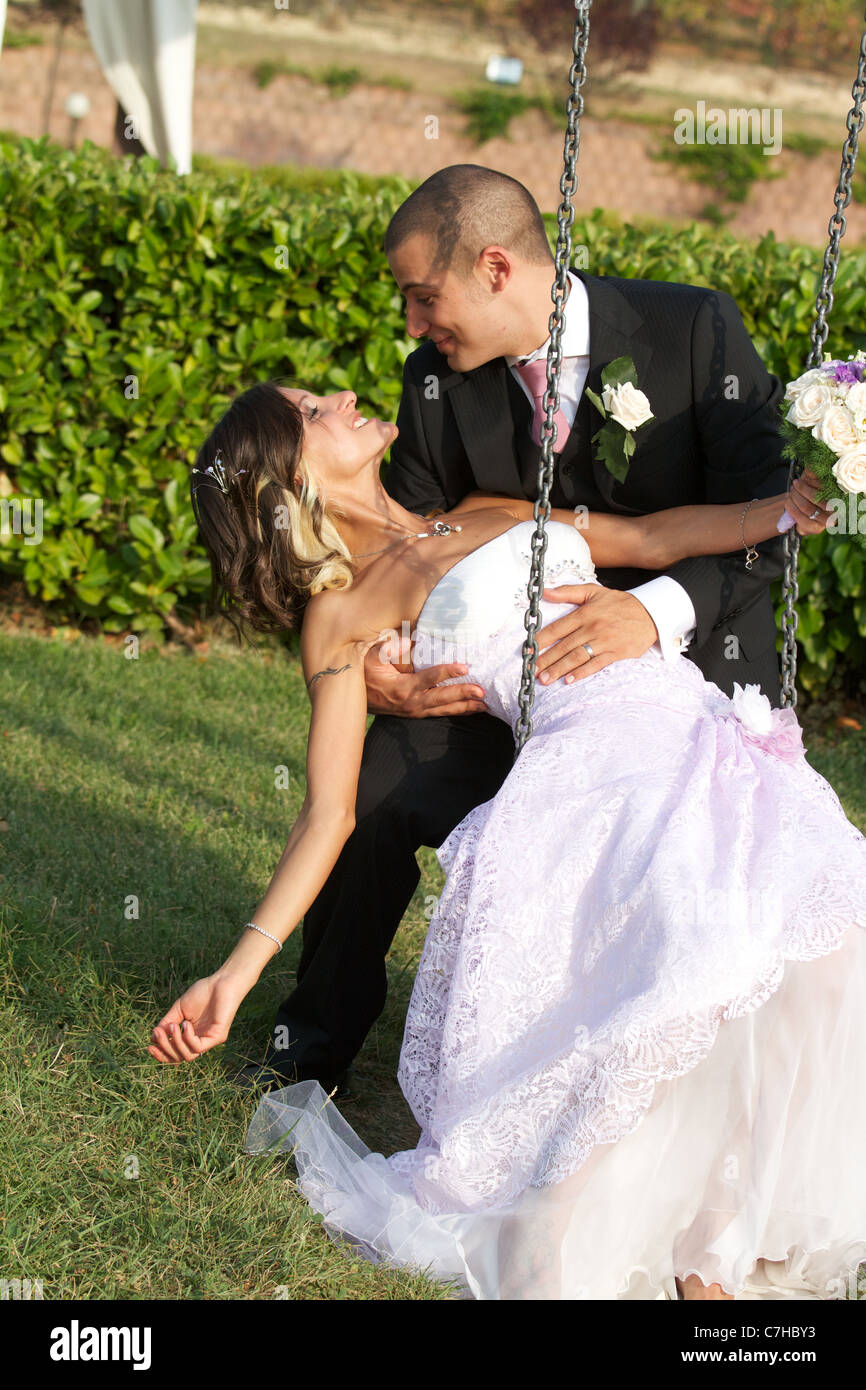 bride and groom kissing on the swing Stock Photo - Alamy