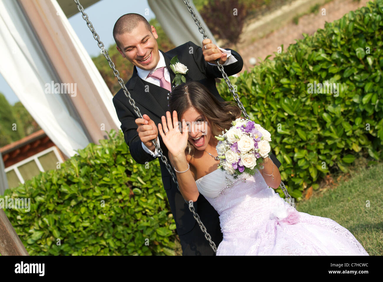bride and groom have fun on the swing Stock Photo - Alamy