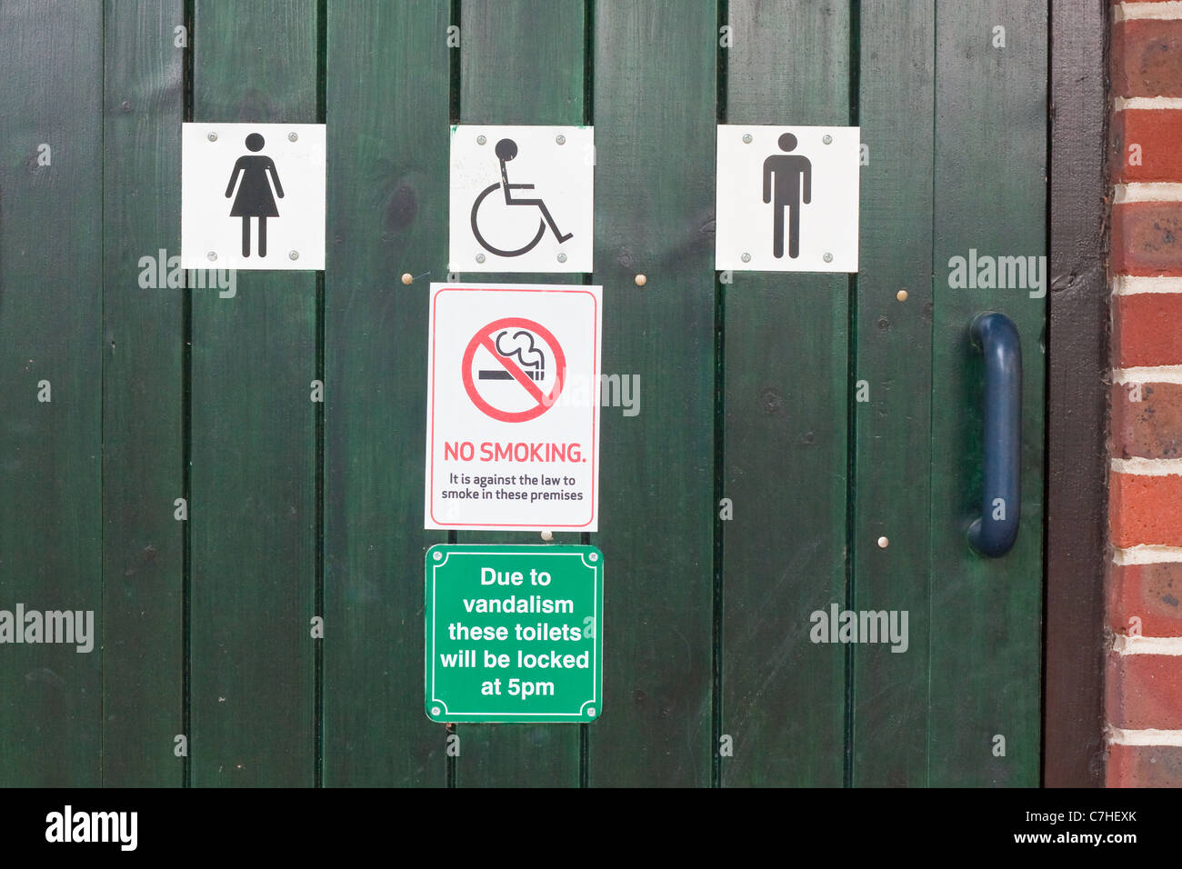 Signs on a toilet door in the UK, indicating closing due to vandalism Stock Photo