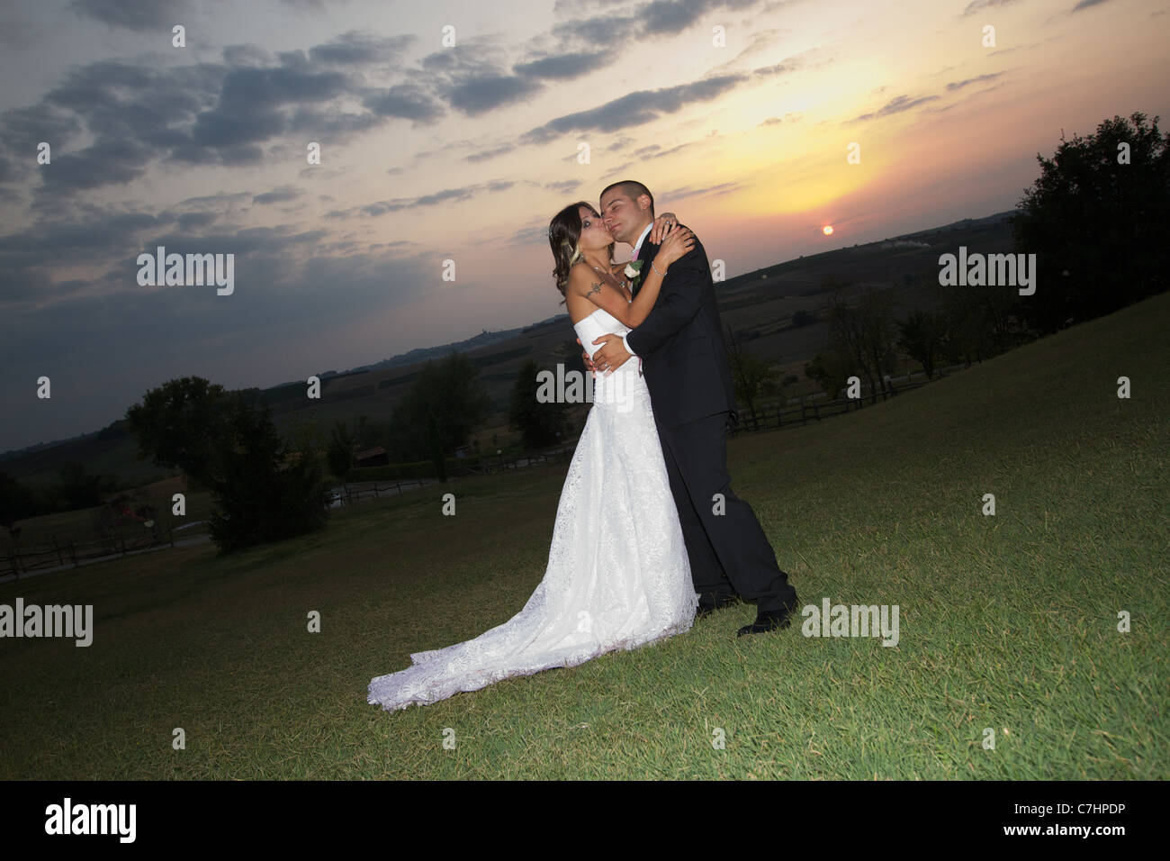 bride and groom kissing on sunset Stock Photo - Alamy
