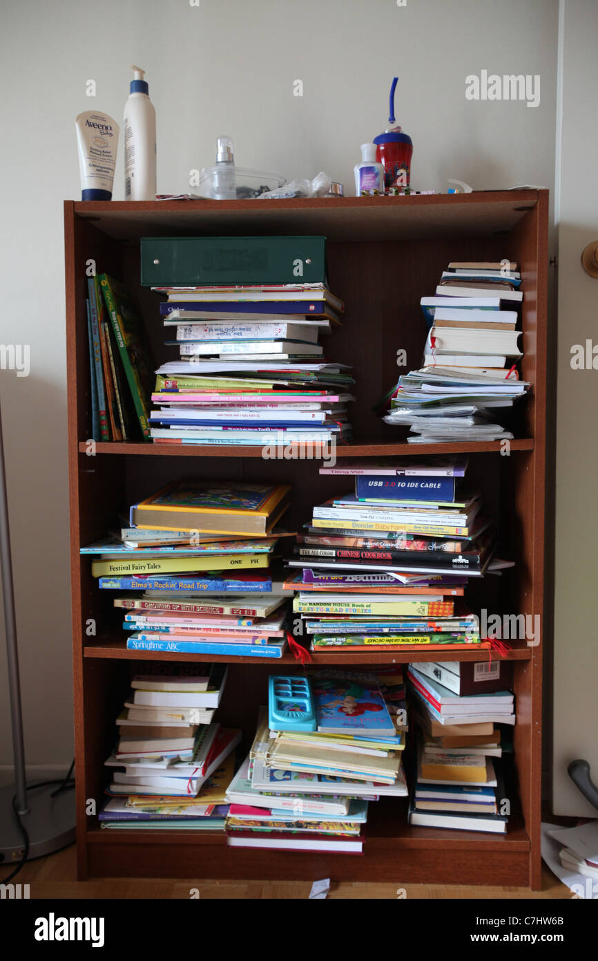 Children's books in an untidy bookshelf Stock Photo
