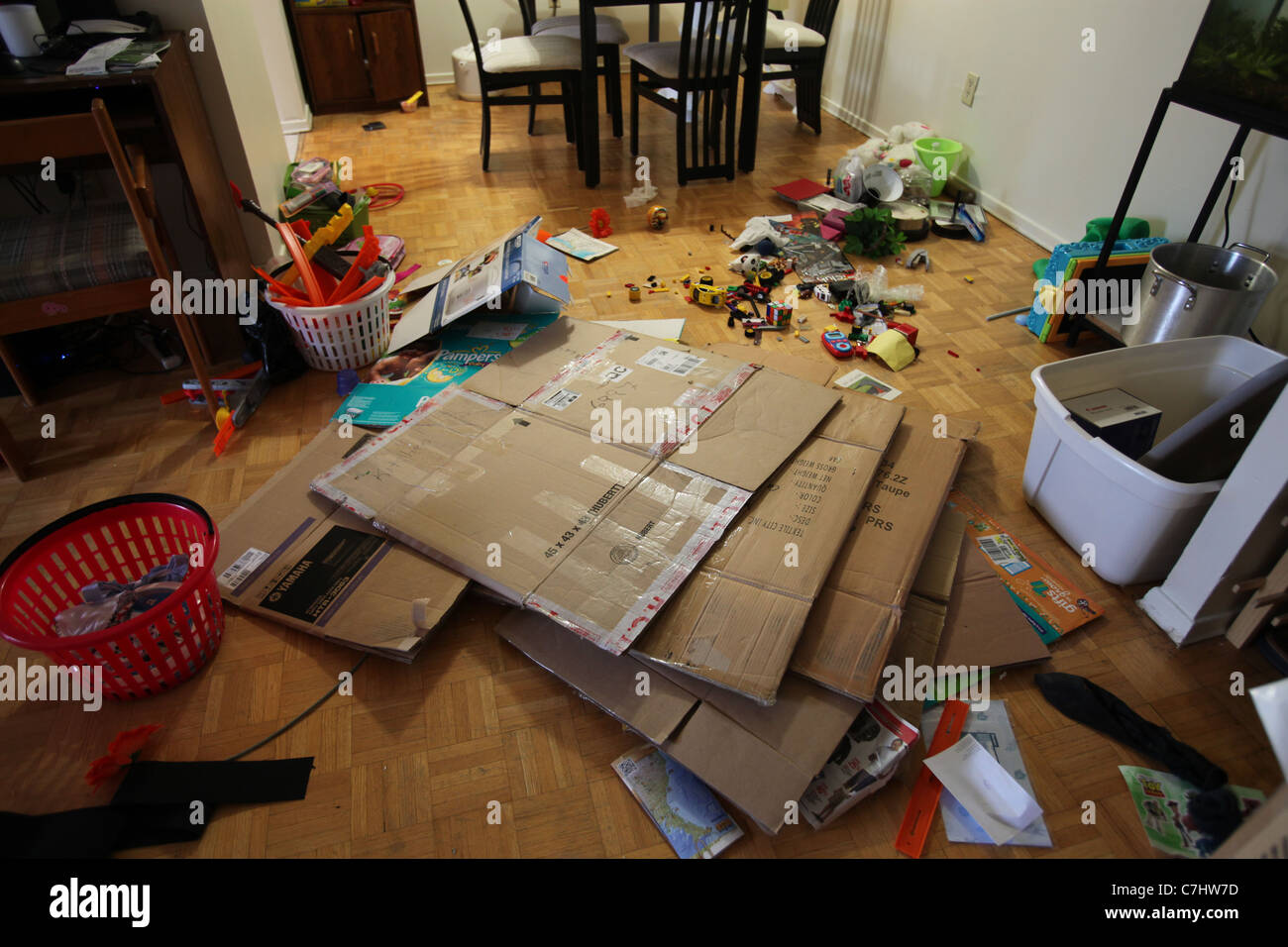 Untidy apartment room with cardboard boxes after moving Stock Photo