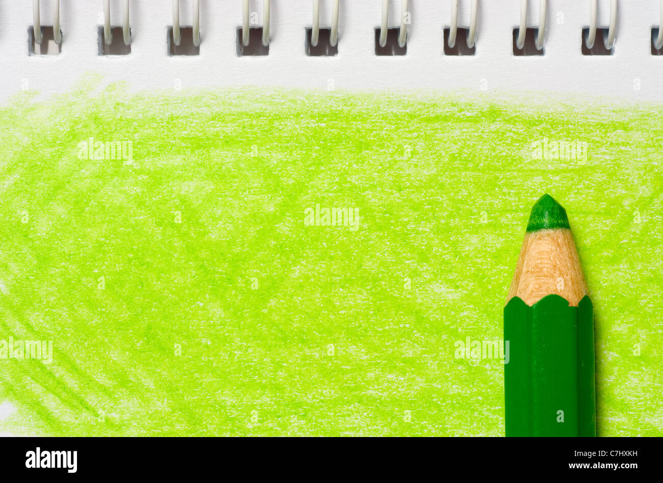 Green color pencil with coloring on a piece of paper Stock Photo