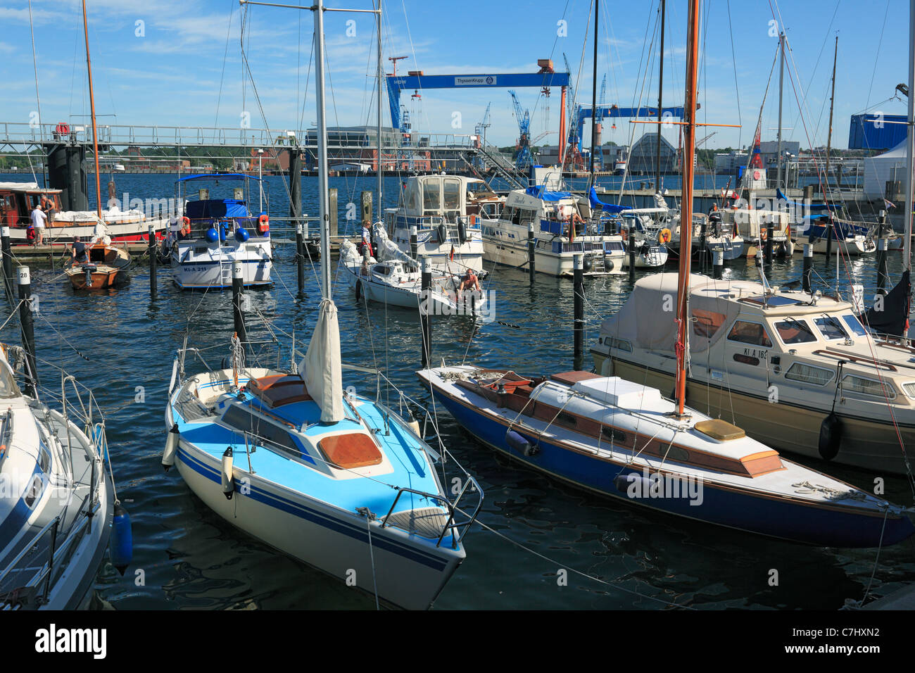 D-Kiel, Kiel Fjord, Baltic Sea, Schleswig-Holstein, D-Kiel-Duesternbrook, Kiel harbour, sports harbour Seeburg at the Kiellinie, sailboats, behind the Howaldtswerke-Deutsche Werft, HDW shipyard, Thyssen Krupp, gantry cranes Stock Photo