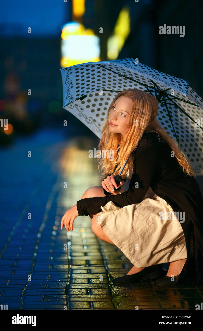 girl with umbrella on street at night Stock Photo - Alamy