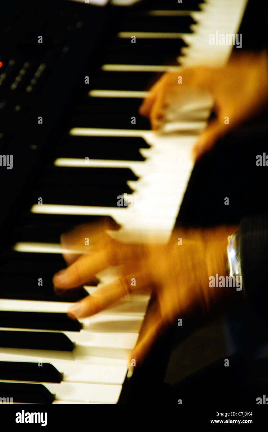 Two hands playing the electronic keyboard Stock Photo