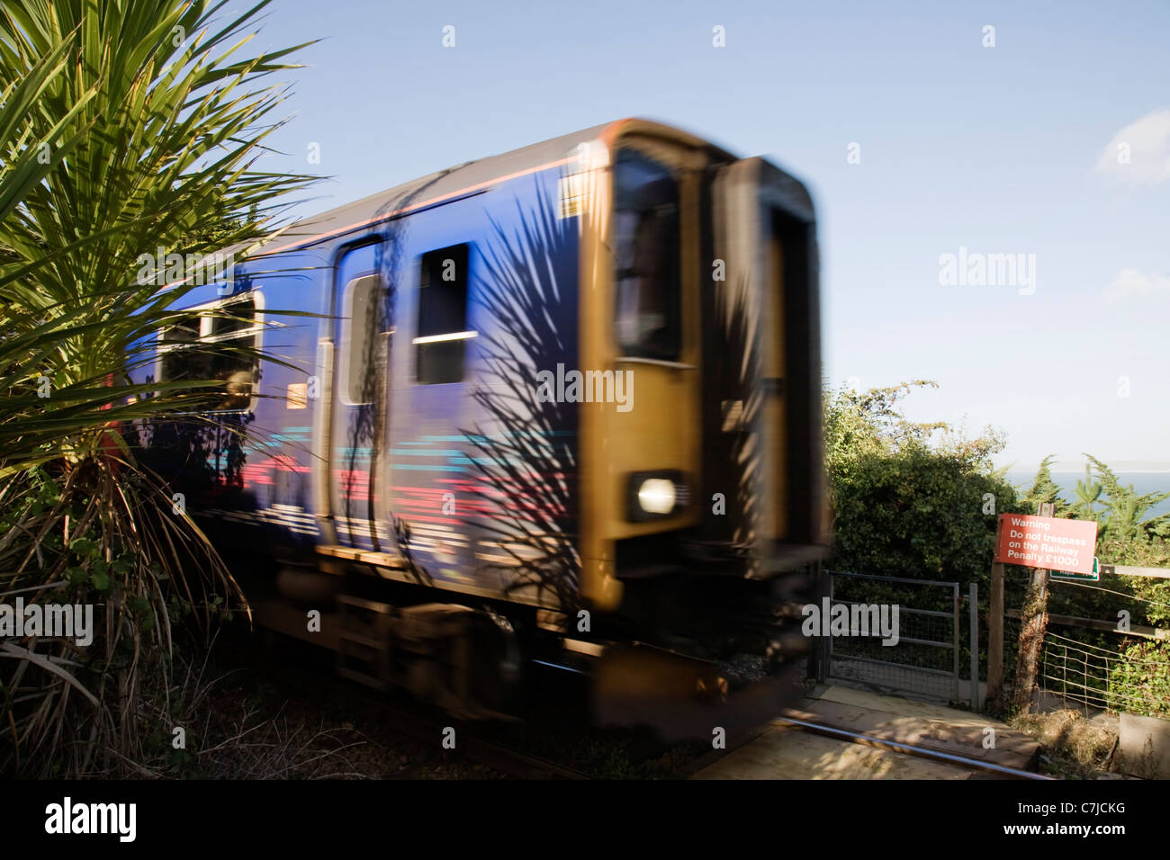 The St Ives train passing by at a crossing near Carbis Bay, Cornwall